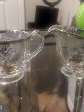 Antique Glass Creamer and Sugar Bowl with Silver Overlay Floral Trim.